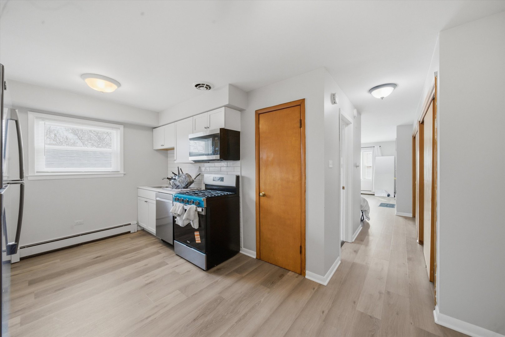 7412 West 63rd Place Summit, IL 60501 - Photo 27 of 49 a kitchen with a refrigerator cabinets and wooden floor