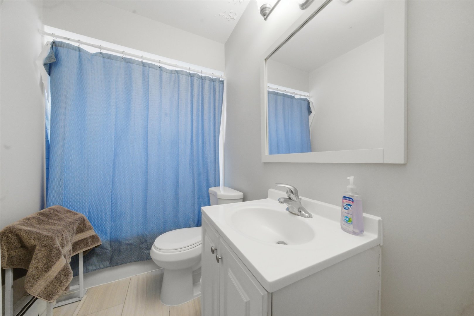 7412 West 63rd Place Summit, IL 60501 - Photo 28 of 49 a bathroom with a sink a toilet and mirror