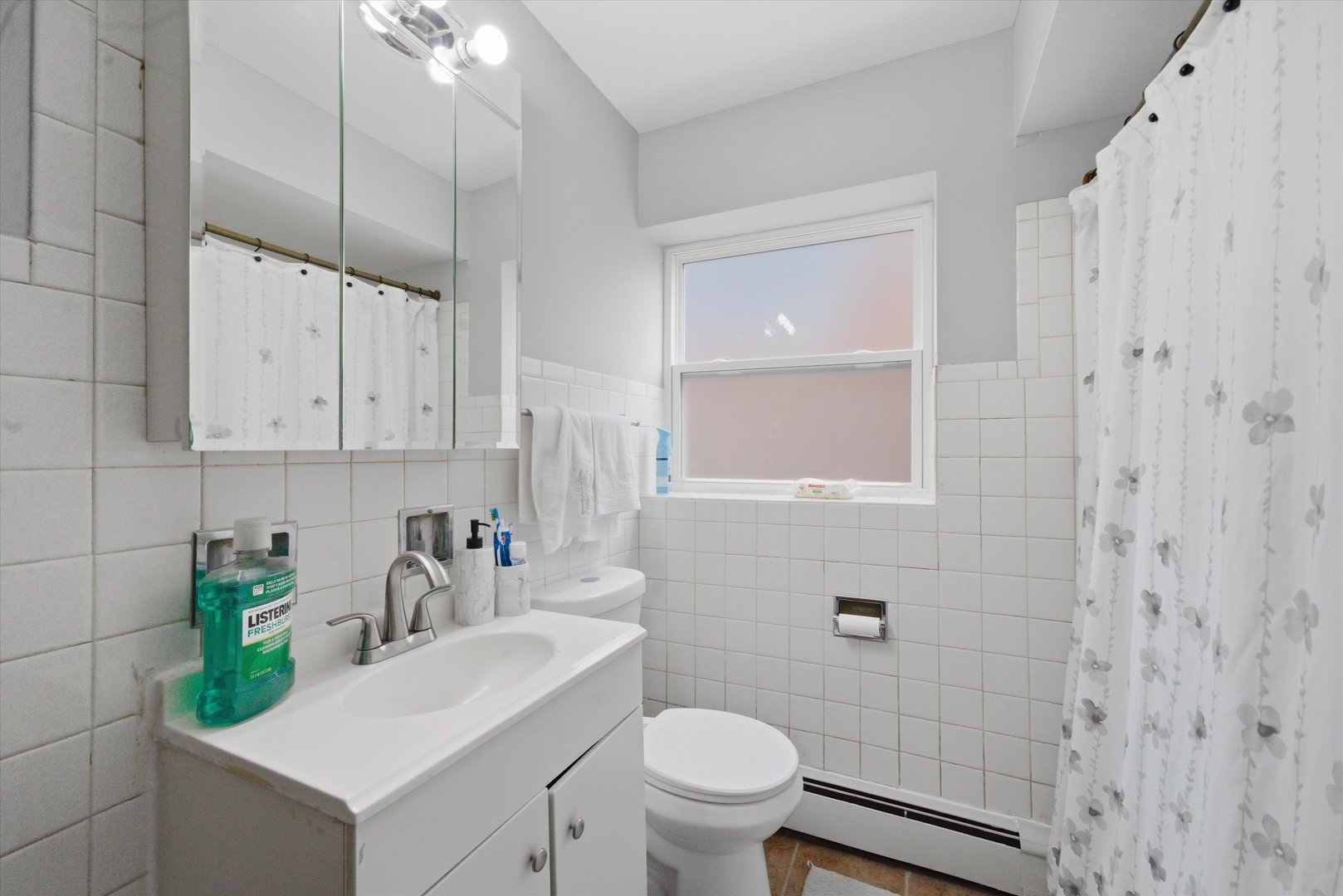 7412 West 63rd Place Summit, IL 60501 - Photo 29 of 49 a bathroom with a sink a toilet and shower