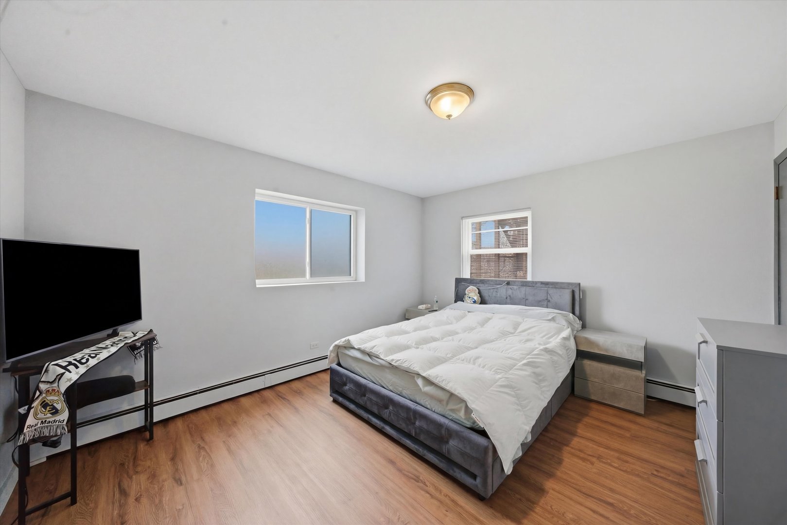 7412 West 63rd Place Summit, IL 60501 - Photo 31 of 49 a living room with a bed furniture and a flat screen tv