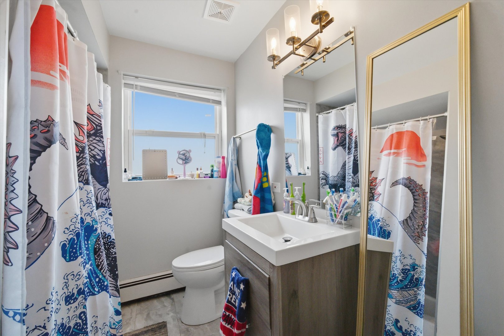 7412 West 63rd Place Summit, IL 60501 - Photo 32 of 49 a bathroom with a sink vanity mirror and toilet