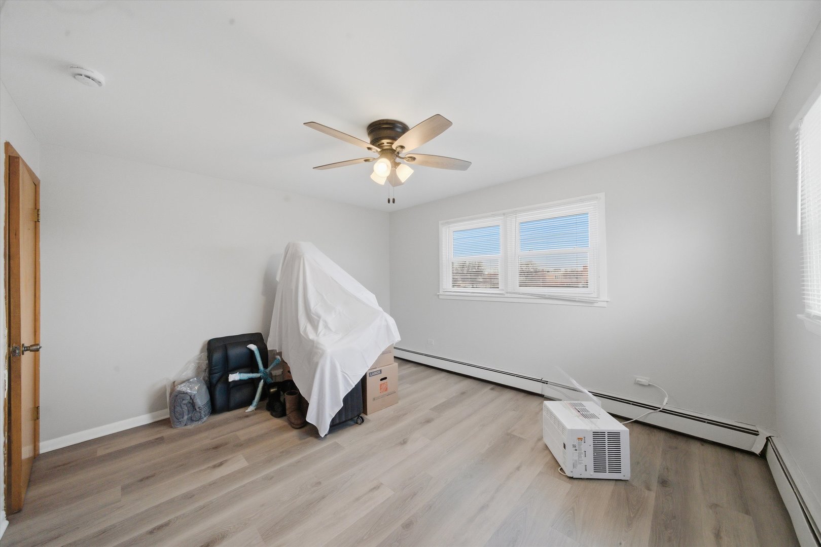 7412 West 63rd Place Summit, IL 60501 - Photo 39 of 49 a view of an empty room with wooden floor and a ceiling fan