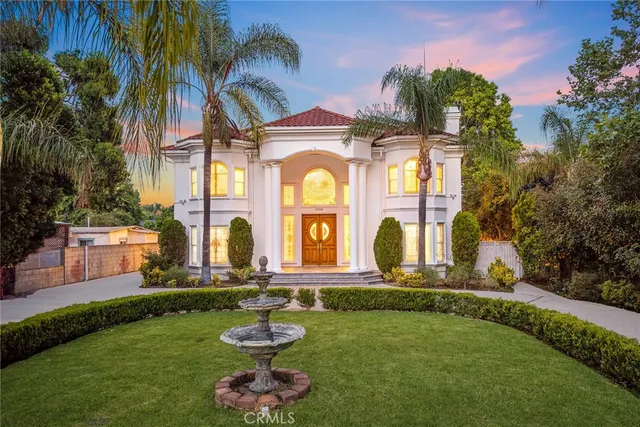 a front view of a house with swimming pool and garden