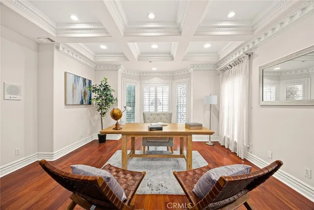a living room with furniture a table and wooden floor