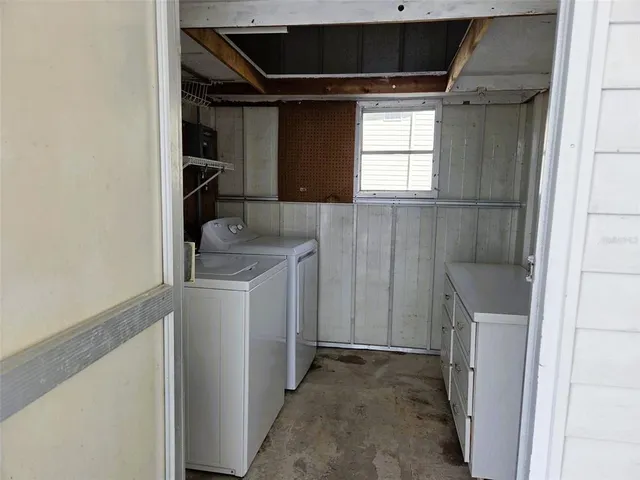 a utility room with cabinets washer and dryer