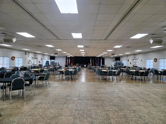 a view of a room with chairs and tables