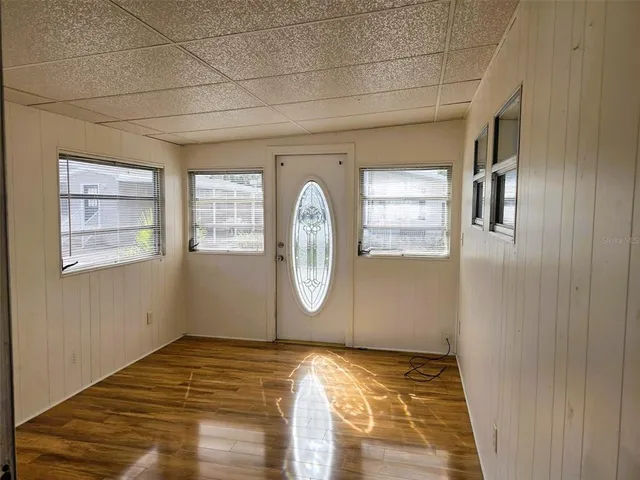 a view of empty room with wooden floor
