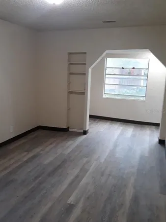 a view of an empty room and a window