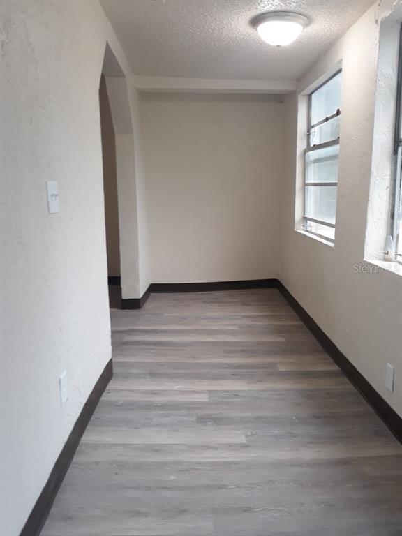 350 Maple Street Daytona Beach, FL 32114 - Photo 6 of 8 a view of an empty room with wooden floor and a window