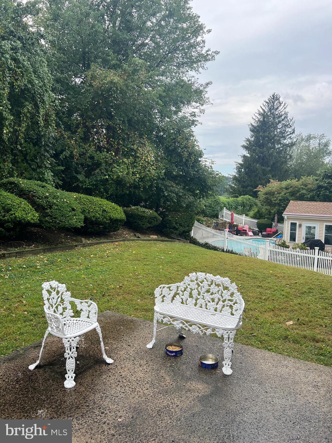 658 West Rolling Road Springfield, PA 19064 - Photo 6 of 15 a view of a table and chairs in the garden near the lake