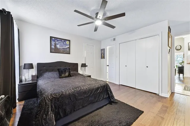 a bedroom with a bed and a ceiling fan