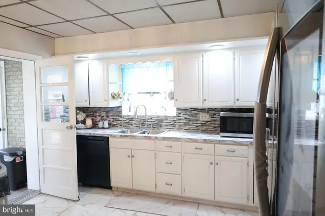 a white toilet sitting next to a wooden cabinet