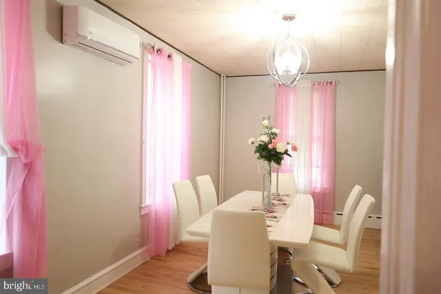 a bedroom with a bed and teddy bear on the dresser
