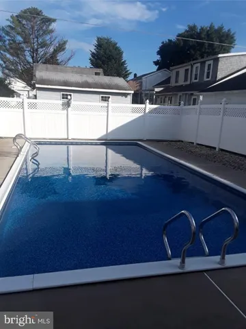 a view of a house with wooden fence