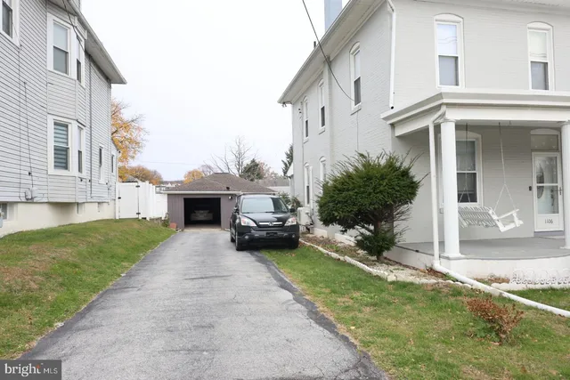 a view of a white house with a swimming pool