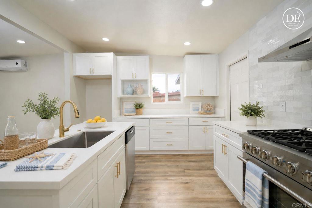 1314 Bluegrass Road Vista, CA 92083 - Photo 3 of 16 a kitchen with a sink stove and white cabinets