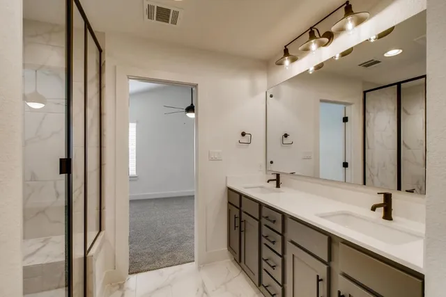 a bathroom with a double vanity sink and mirror