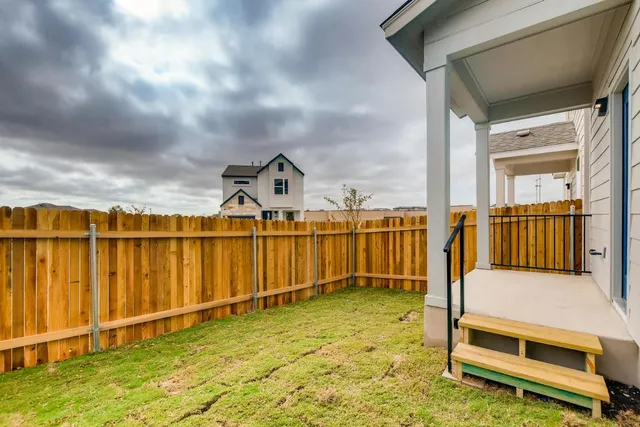 a view of a backyard with a fence