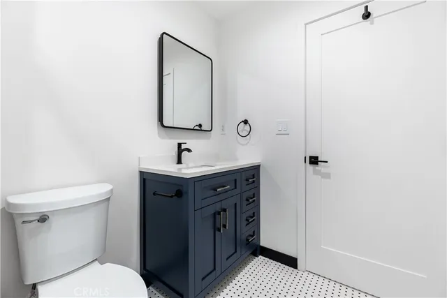 a bathroom with a sink a toilet and mirror