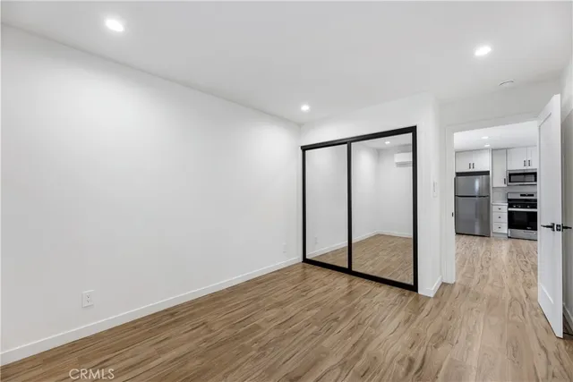a view of a room with wooden floor