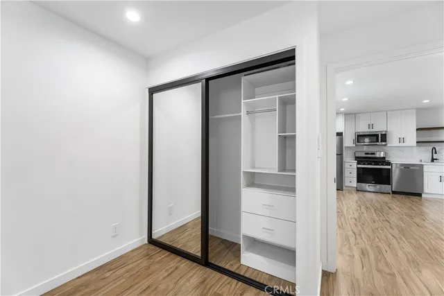 a view of a kitchen with wooden floor and a sink