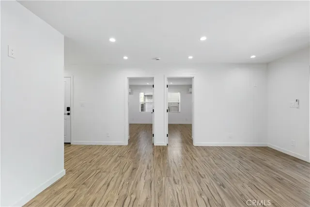 a view of empty room with wooden floor