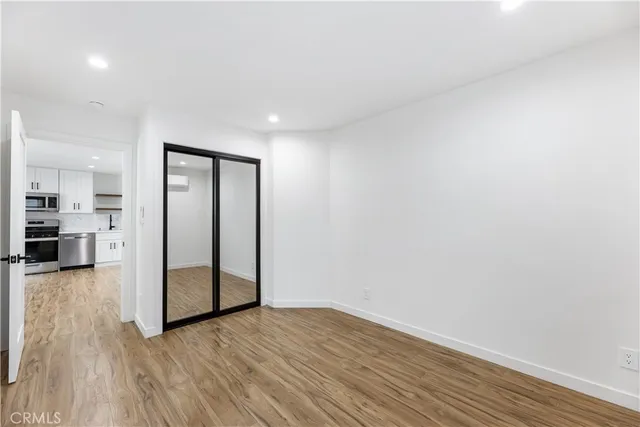 a view of a room with wooden floor and furniture