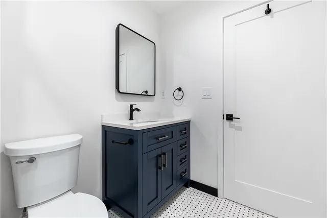 a bathroom with a sink a toilet and mirror