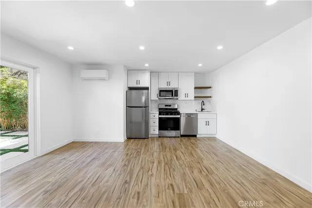 a kitchen with stainless steel appliances a refrigerator and a stove top oven