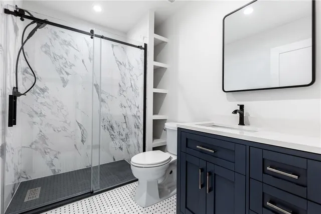 a bathroom with a sink a toilet and shower