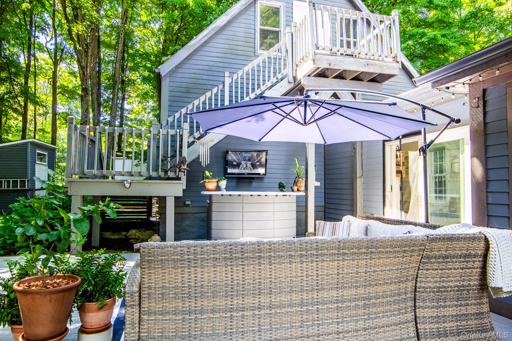 195 Pressler Road Wallkill, NY 12589 - Photo 39 of 47 Sitting area of the deck with bar and TVEntry area for the unfinished storage area over the garage