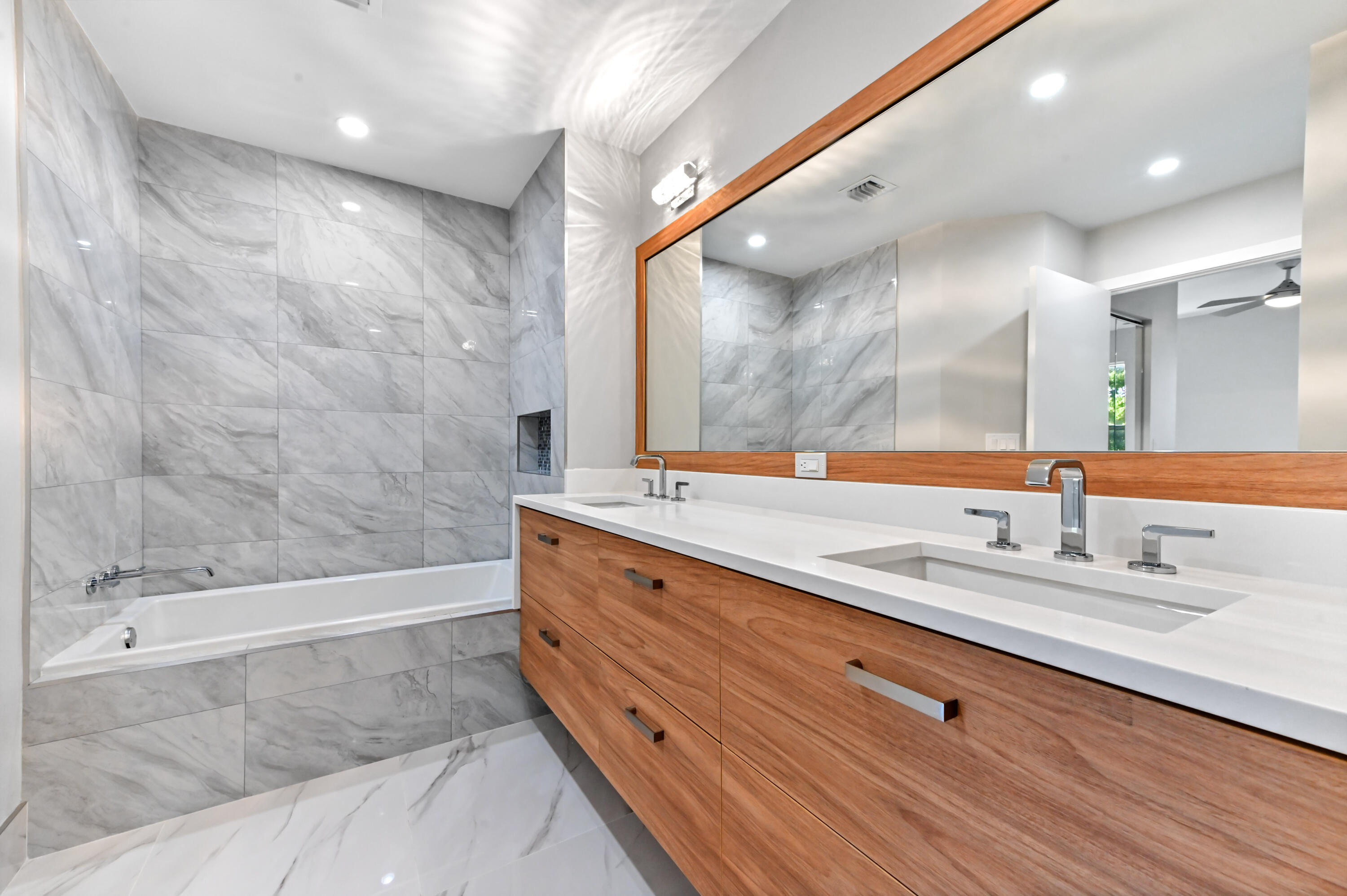 12510 Crystal Pointe Drive, Unit 102 Boynton Beach, FL 33437 - Photo 15 of 27 a bathroom with a granite countertop sink mirror and bathtub
