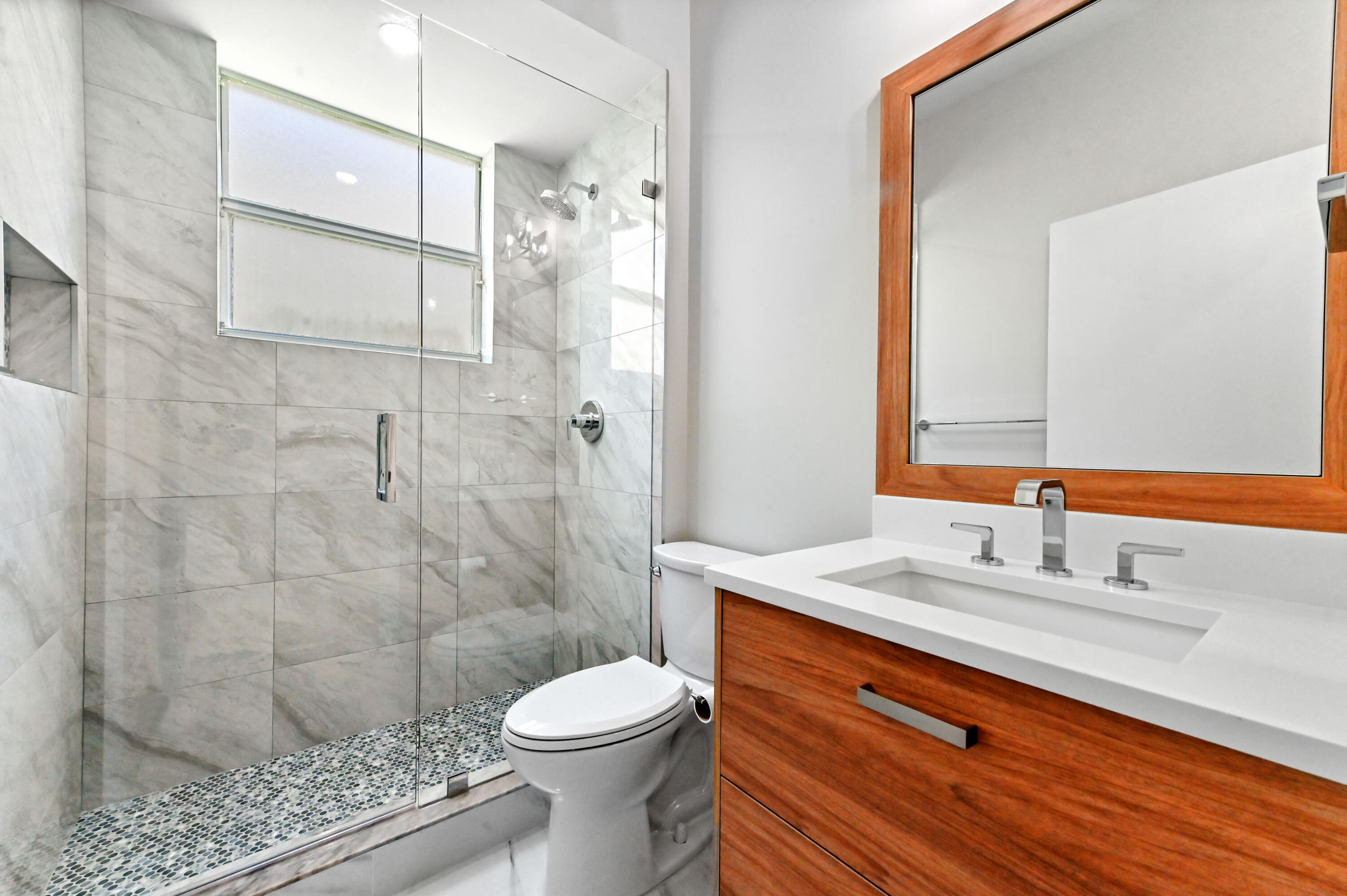 12510 Crystal Pointe Drive, Unit 102 Boynton Beach, FL 33437 - Photo 16 of 27 a bathroom with a sink a toilet and shower