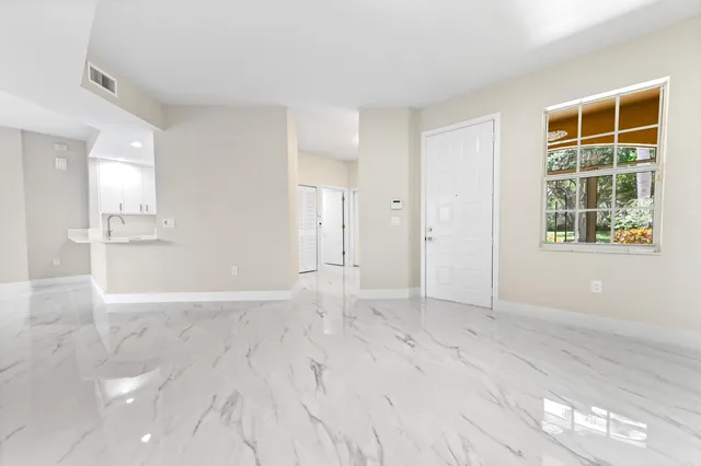 an empty room with windows and entrance