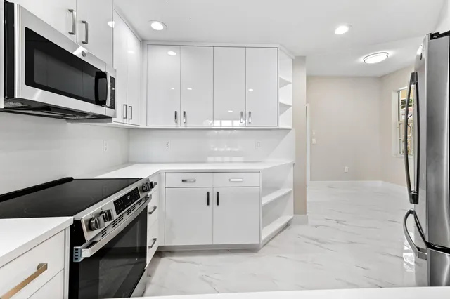 a kitchen with granite countertop a stove and a sink