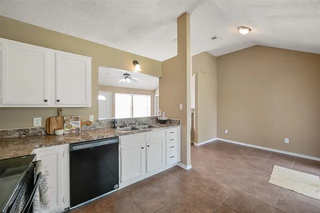 a kitchen with a sink a stove and cabinets