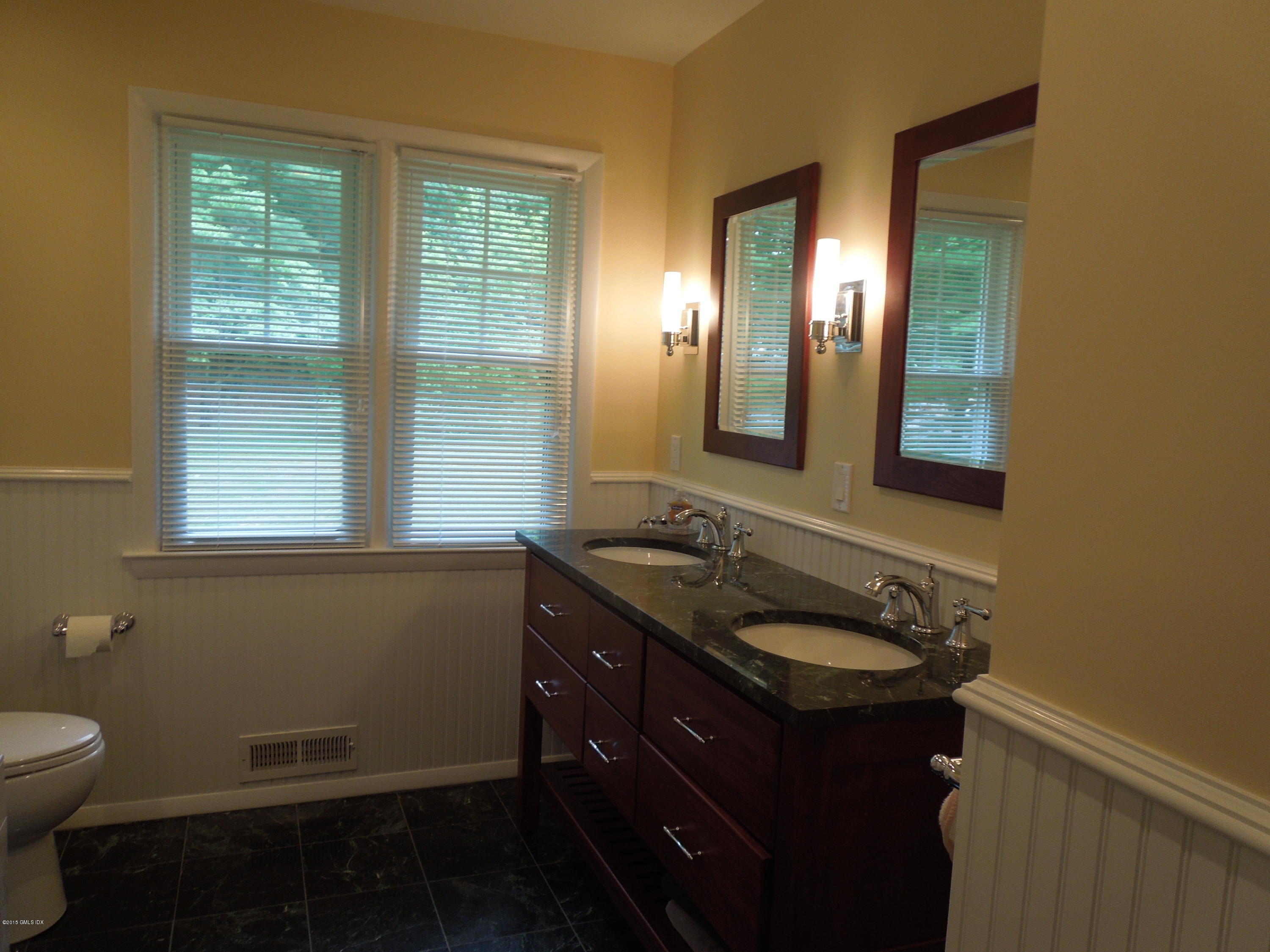 408 Taconic Road Greenwich, CT 06831 - Photo 14 of 18 a bathroom with a granite countertop sink toilet and mirror