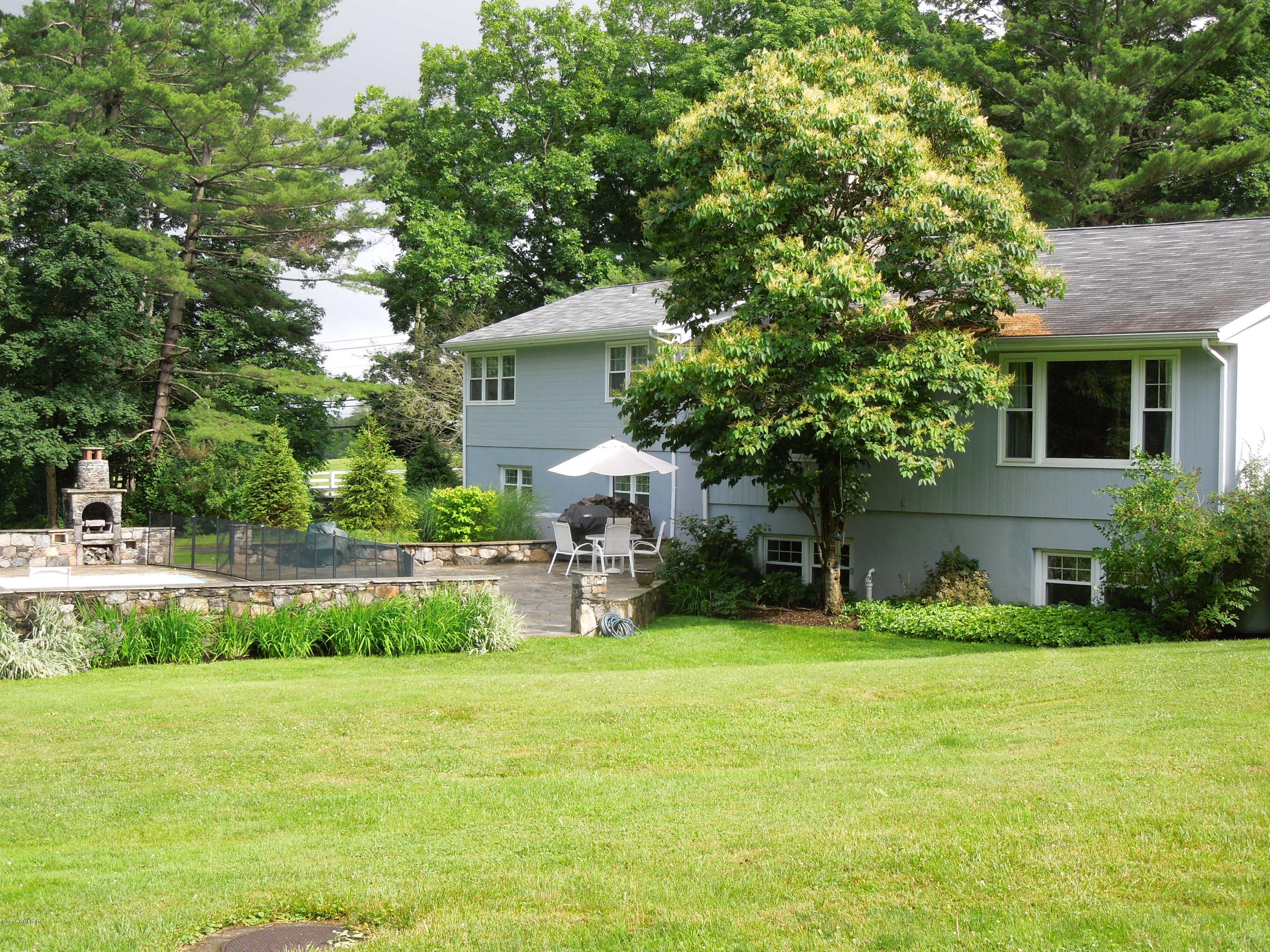 408 Taconic Road Greenwich, CT 06831 - Photo 18 of 18 a view of a house with a yard and sitting area