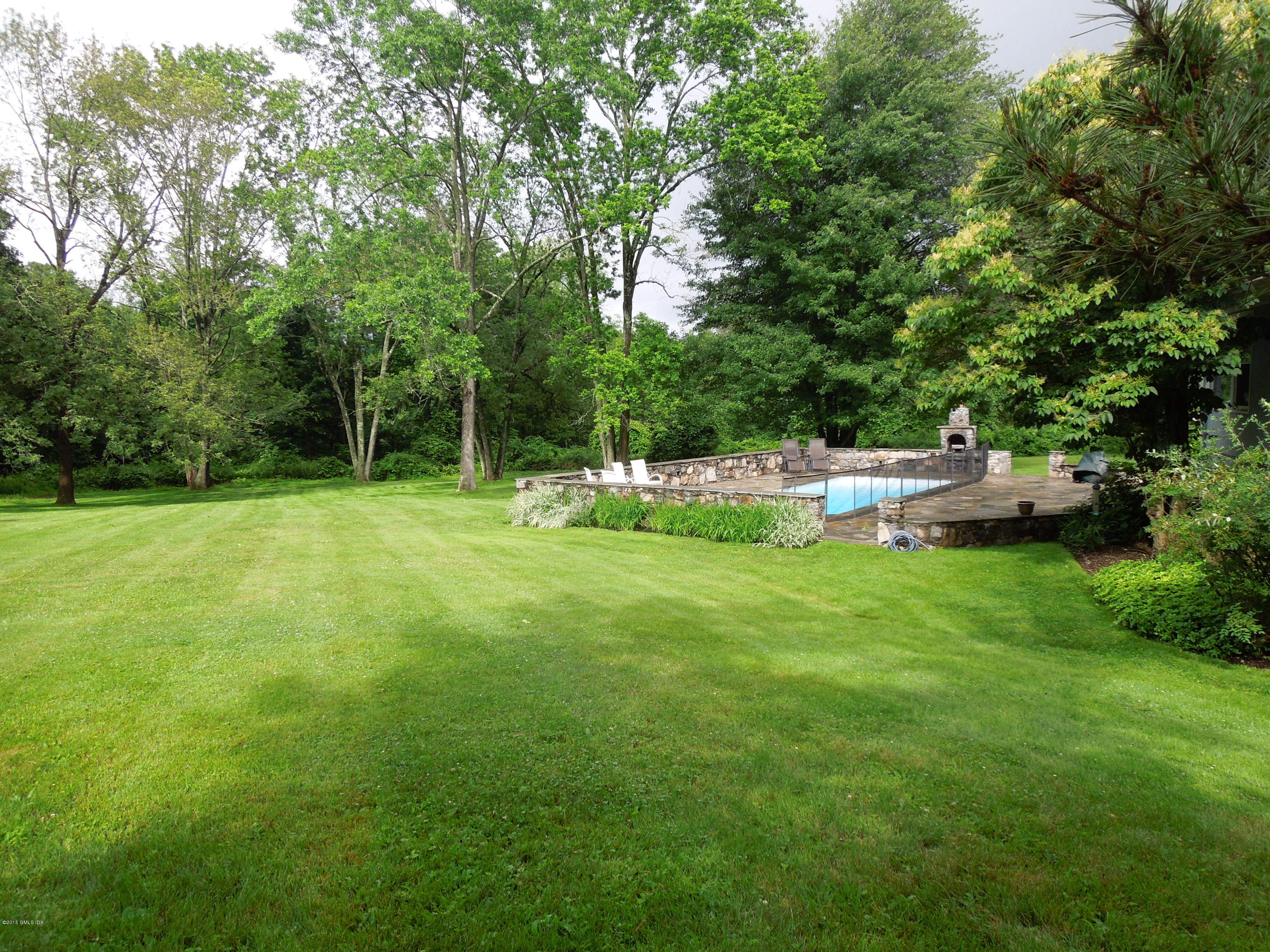 408 Taconic Road Greenwich, CT 06831 - Photo 2 of 18 a view of yard with grass and trees