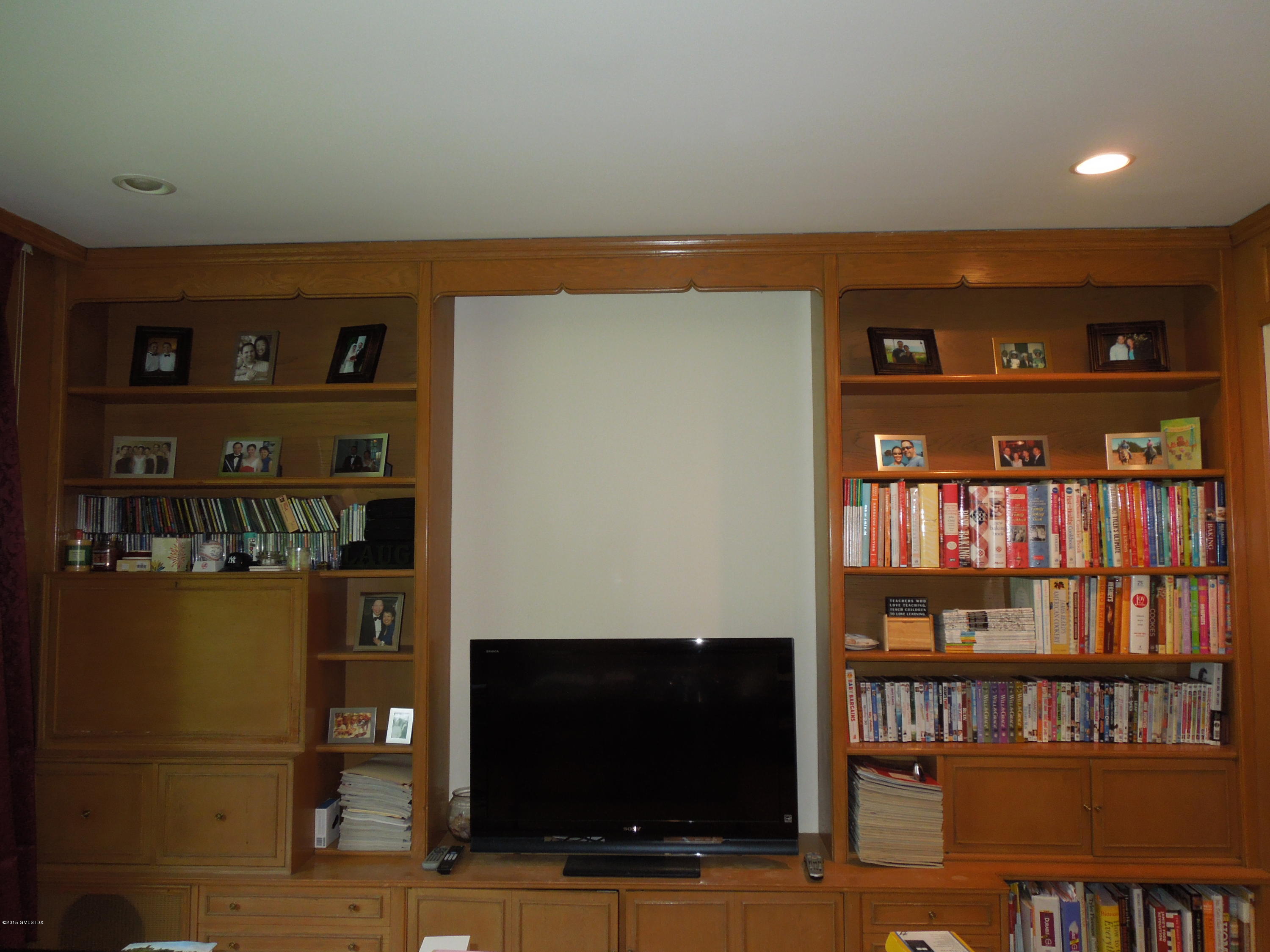 408 Taconic Road Greenwich, CT 06831 - Photo 6 of 18 a living room with hard wood floors and a book shelf