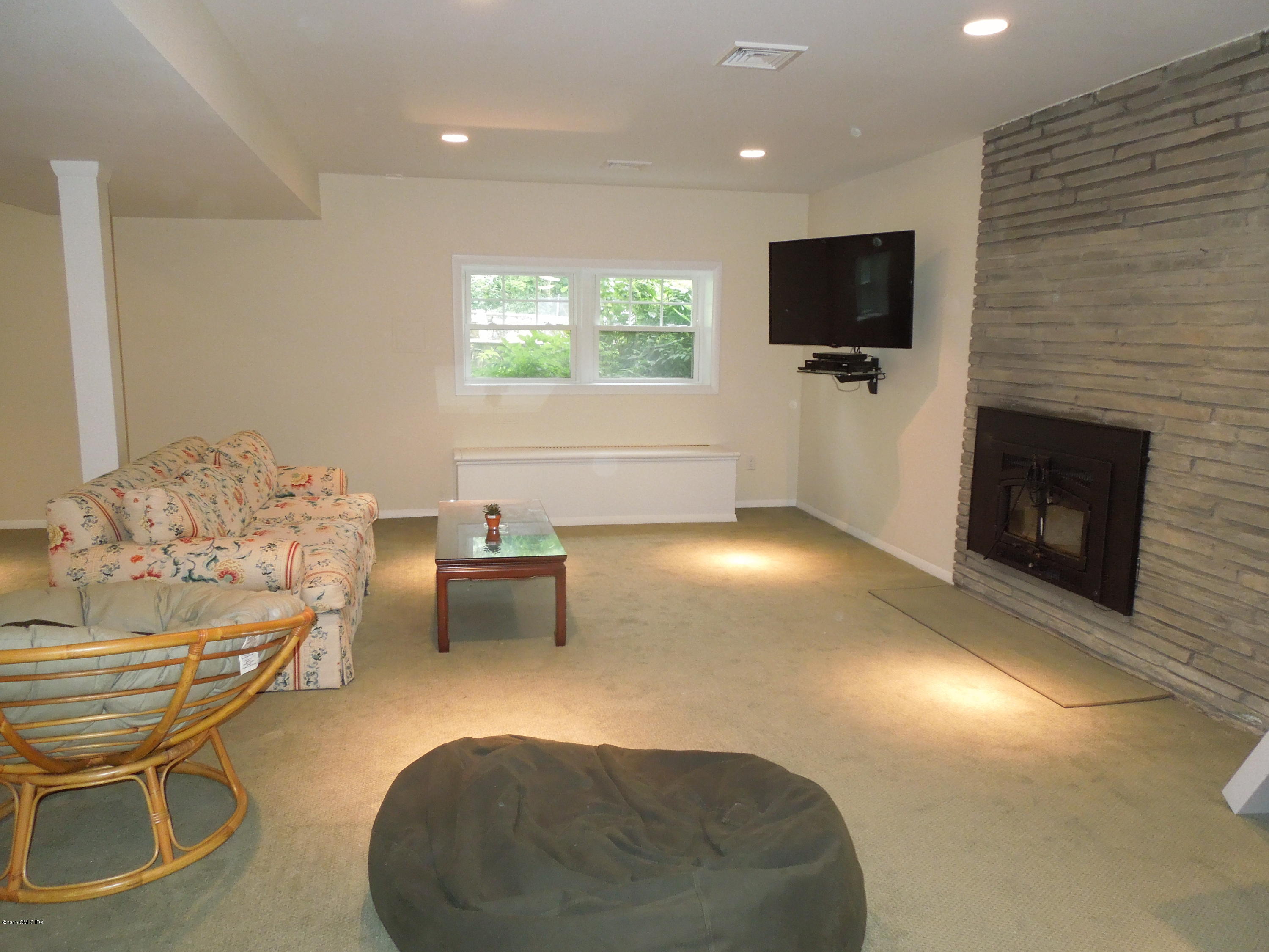 408 Taconic Road Greenwich, CT 06831 - Photo 7 of 18 a living room with furniture and a flat screen tv