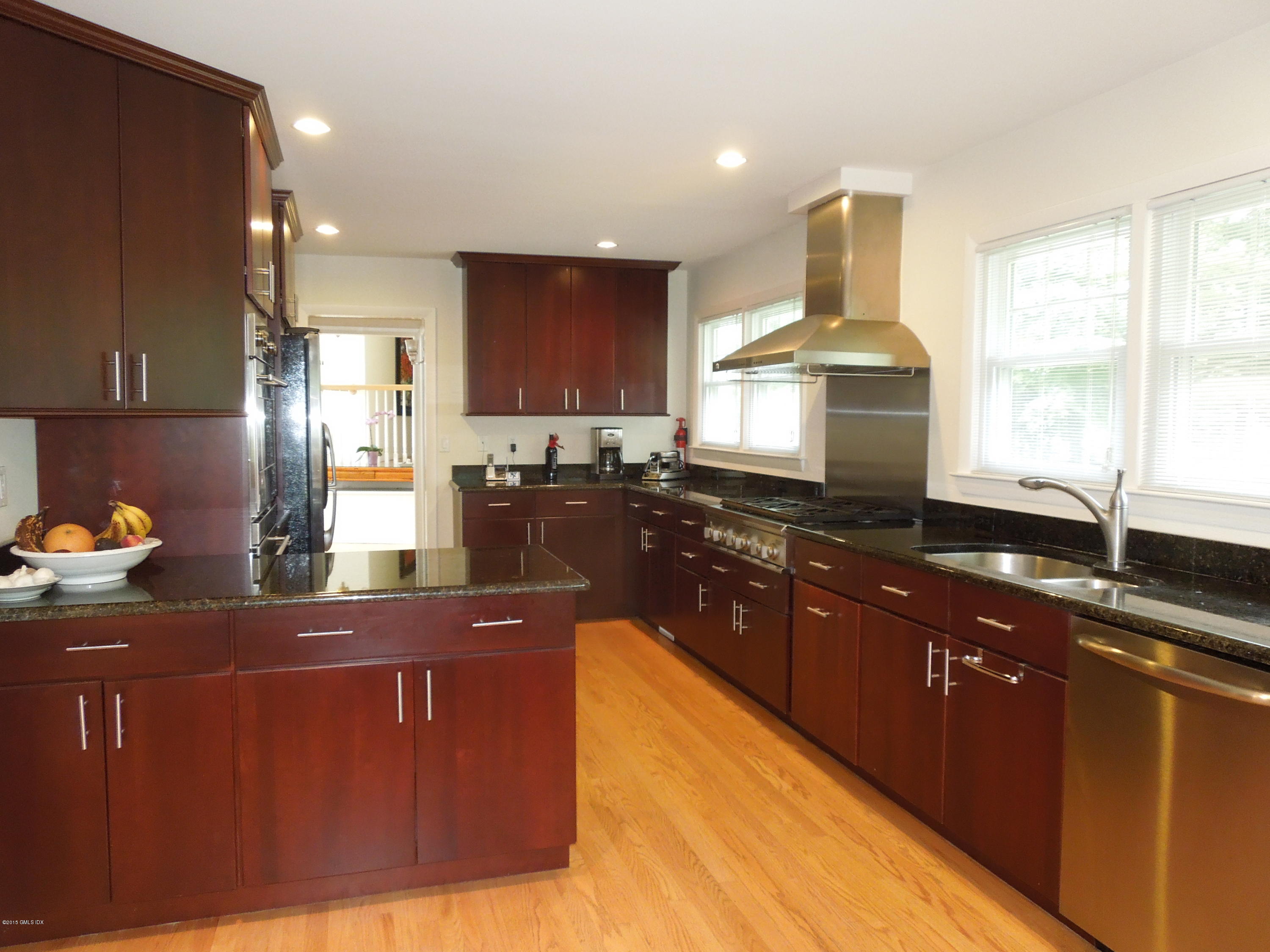 408 Taconic Road Greenwich, CT 06831 - Photo 9 of 18 a kitchen with stainless steel appliances granite countertop wooden cabinets a stove a sink and a granite counter tops