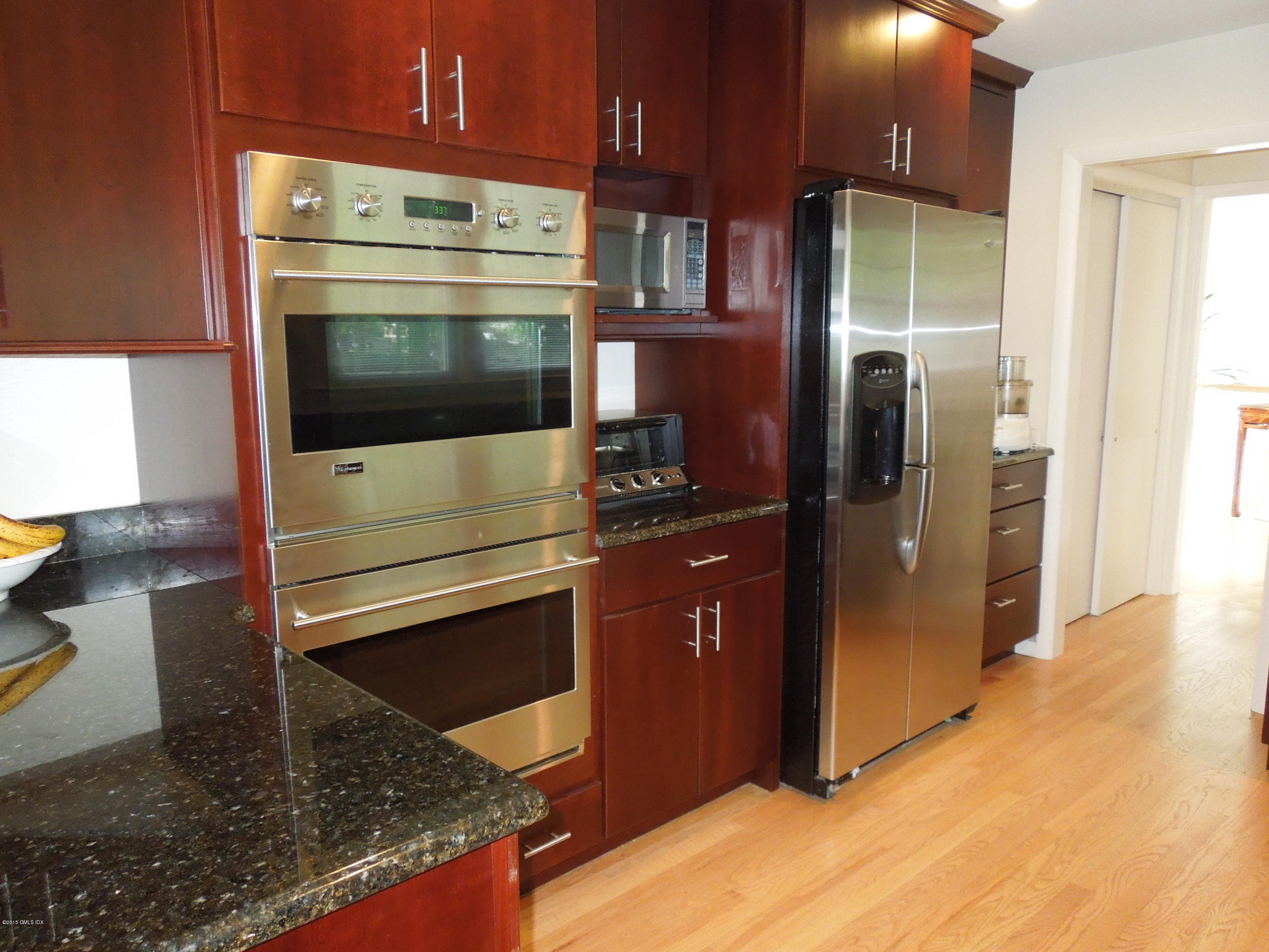 408 Taconic Road Greenwich, CT 06831 - Photo 10 of 18 a kitchen with stainless steel appliances kitchen island granite countertop a refrigerator and a stove