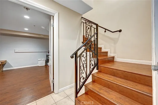 a view of entryway and hall with wooden floor