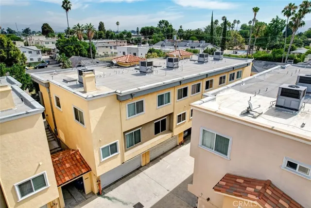 an aerial view of residential houses with outdoor space