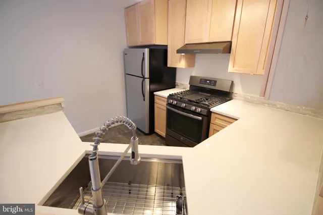 a kitchen with a stove and a refrigerator