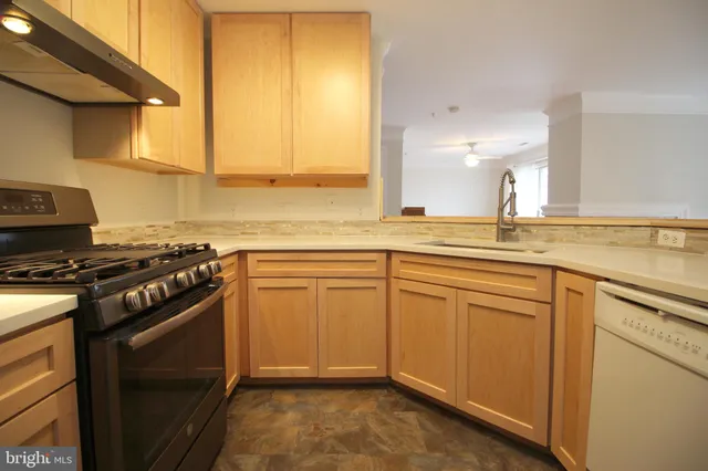 a kitchen with stainless steel appliances granite countertop a stove and a sink