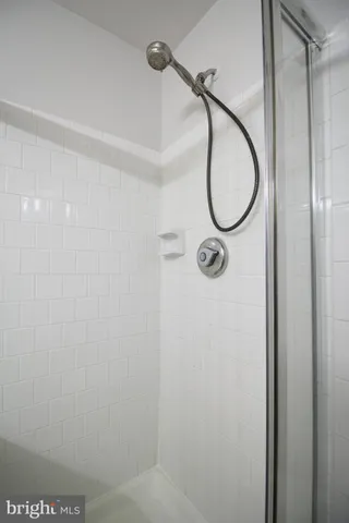 a bathroom with a shower and a mirror