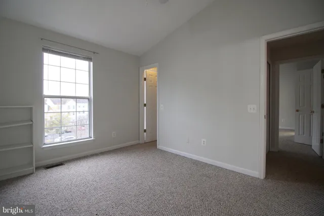 an empty room with windows and closet