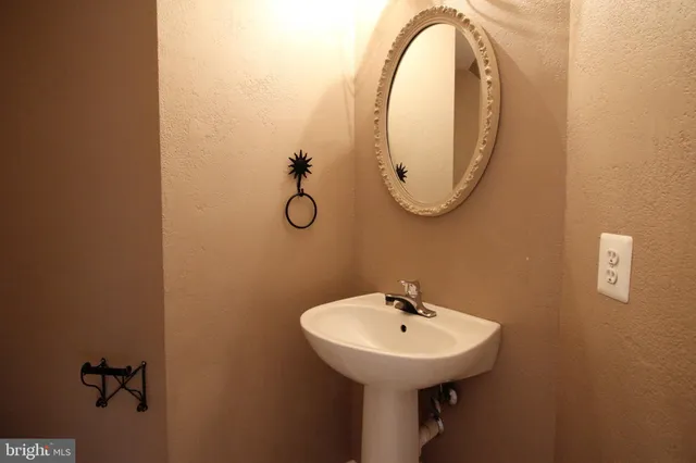 a bathroom with a sink and mirror